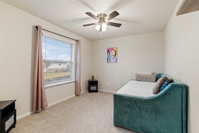 bedroom with light carpet, a ceiling fan, and baseboards