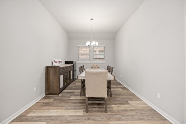 dining room featuring a notable chandelier and light hardwood / wood-style flooring