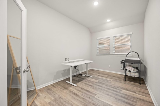 home office featuring light hardwood / wood-style floors and lofted ceiling