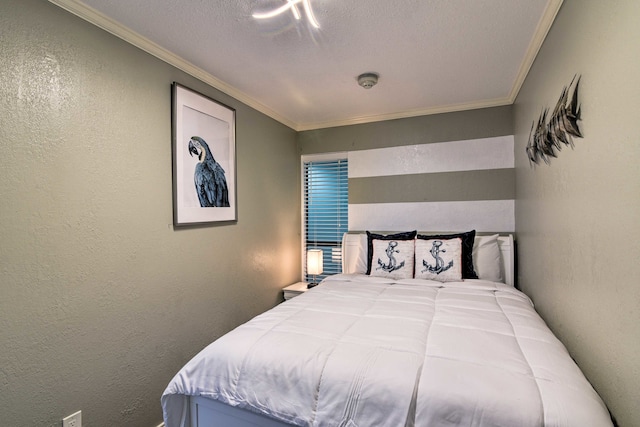 bedroom featuring ornamental molding and a textured ceiling