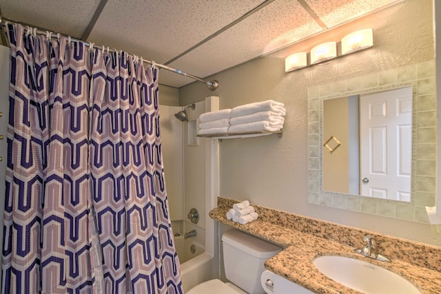 full bathroom with a drop ceiling, toilet, shower / bath combo, and vanity