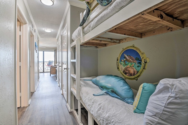 hallway featuring hardwood / wood-style floors and crown molding