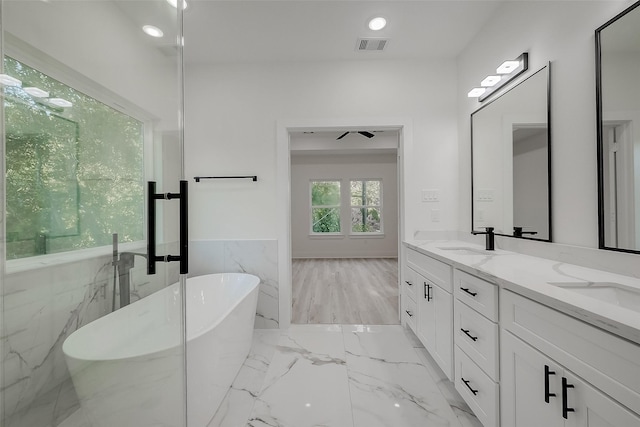 bathroom with vanity and a bath