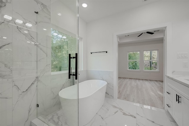 bathroom with hardwood / wood-style flooring, ceiling fan, vanity, and independent shower and bath