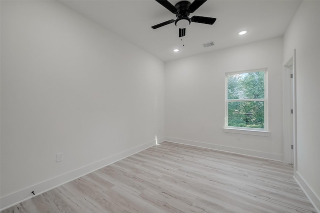 empty room with ceiling fan and light wood-type flooring