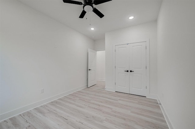 unfurnished bedroom featuring a closet, light hardwood / wood-style flooring, and ceiling fan