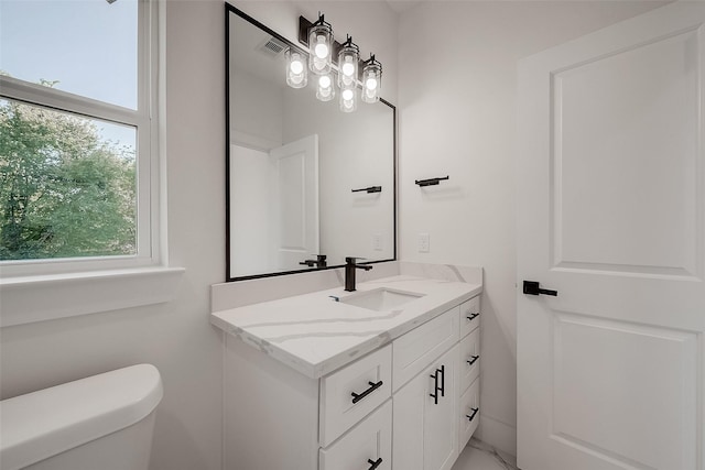 bathroom with vanity and toilet