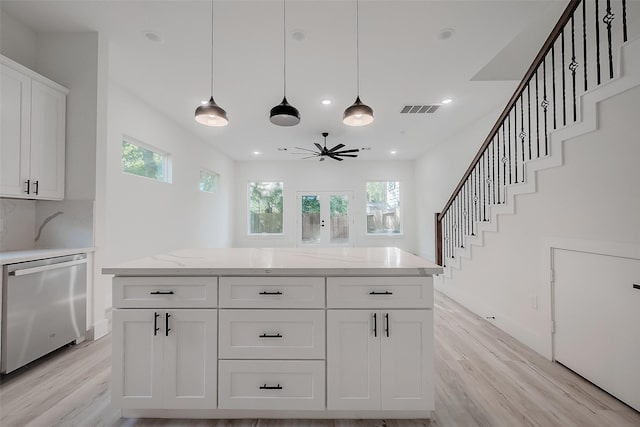 kitchen with white cabinetry, a healthy amount of sunlight, ceiling fan, and stainless steel dishwasher