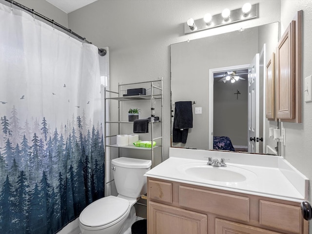 bathroom with a shower with curtain, ceiling fan, toilet, and vanity