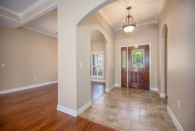 foyer featuring light wood-type flooring and crown molding