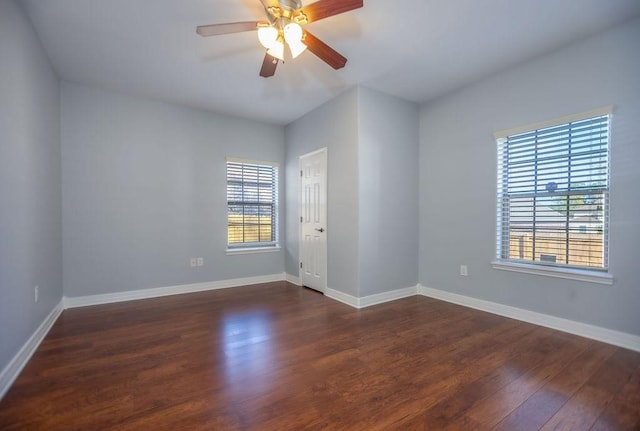 empty room featuring ceiling fan and dark hardwood / wood-style flooring