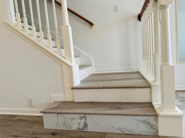 staircase featuring wood-type flooring