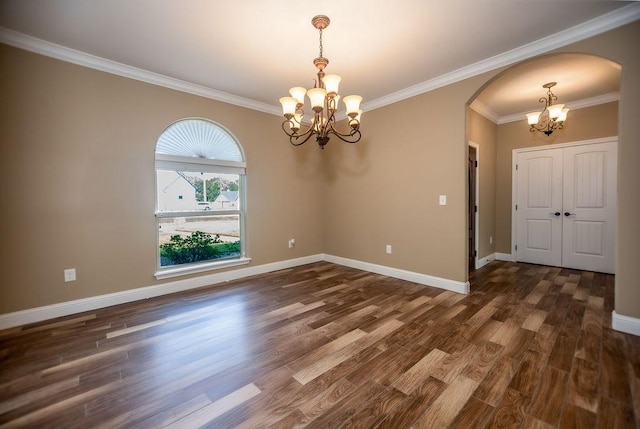 unfurnished room featuring crown molding, dark hardwood / wood-style flooring, and a notable chandelier