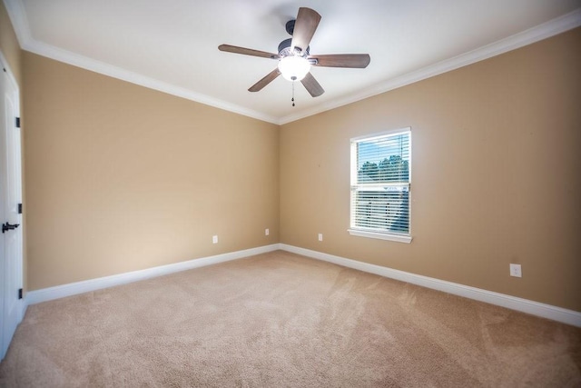 empty room with ornamental molding, carpet flooring, and ceiling fan