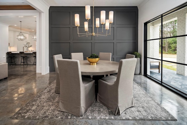 dining space with crown molding and a notable chandelier