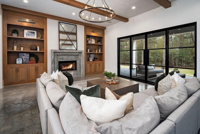 living room with built in shelves, a premium fireplace, and beamed ceiling