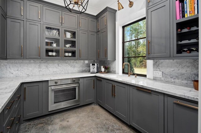 7010 Bowie Ct, Montgomery, TX 77316 - kitchen with oven, gray cabinets, and tasteful backsplash