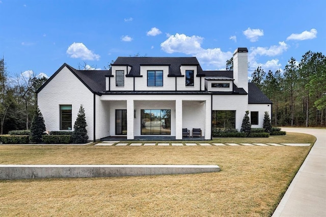 view of front of home with a front yard and covered porch