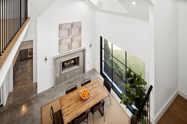 living room featuring a premium fireplace and a high ceiling