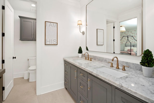 bathroom featuring tile patterned flooring, vanity, toilet, and crown molding