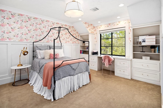 carpeted bedroom featuring built in desk and crown molding