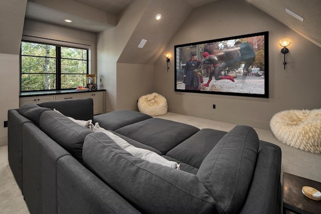 carpeted home theater room featuring lofted ceiling