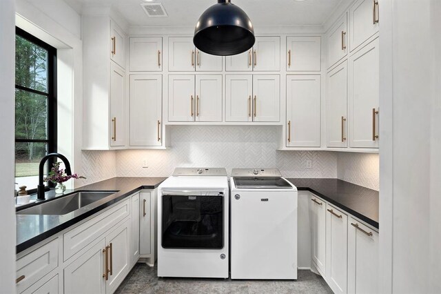 7010 Bowie Ct, Montgomery, TX 77316 - washroom featuring independent washer and dryer and cabinet space