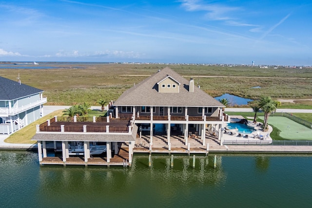 rear view of property with a rural view and a water view