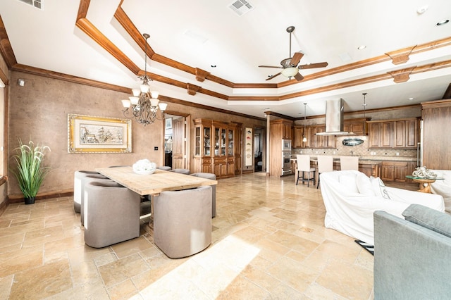 1245 Lagoon Dr, Crystal Beach, TX 77650 - dining room featuring ceiling fan with notable chandelier, ornamental molding, and a tray ceiling