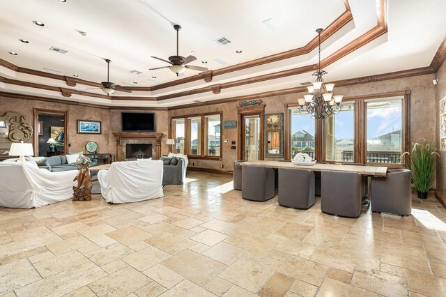 1245 Lagoon Dr, Crystal Beach, TX 77650 - living room with plenty of natural light, a raised ceiling, ceiling fan with notable chandelier, and crown molding