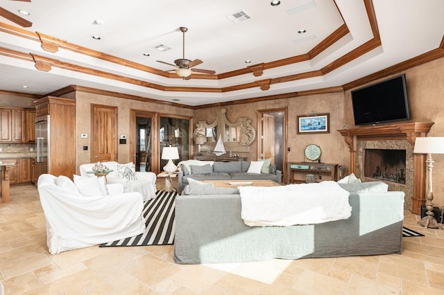 1245 Lagoon Dr, Crystal Beach, TX 77650 - living room with a raised ceiling, a premium fireplace, ceiling fan, and ornamental molding