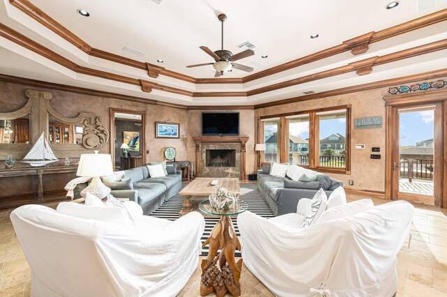 1245 Lagoon Dr, Crystal Beach, TX 77650 - living room with a tray ceiling, a premium fireplace, ceiling fan, and ornamental molding