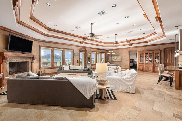1245 Lagoon Dr, Crystal Beach, TX 77650 - living room with crown molding, a high end fireplace, and a tray ceiling