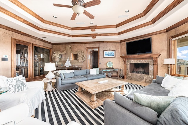 1245 Lagoon Dr, Crystal Beach, TX 77650 - living room featuring a fireplace, a tray ceiling, and crown molding