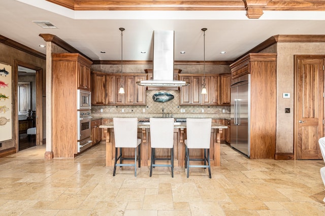 1245 Lagoon Dr, Crystal Beach, TX 77650 - kitchen with island exhaust hood, built in appliances, a center island, hanging light fixtures, and a breakfast bar area