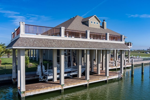 1245 Lagoon Dr, Crystal Beach, TX 77650 - view of dock with a balcony and a water view