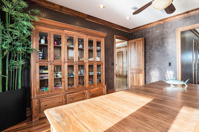 1245 Lagoon Dr, Crystal Beach, TX 77650 - unfurnished dining area with hardwood / wood-style floors, ceiling fan, and crown molding