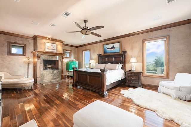 1245 Lagoon Dr, Crystal Beach, TX 77650 - bedroom with a fireplace, hardwood / wood-style floors, multiple windows, and ceiling fan