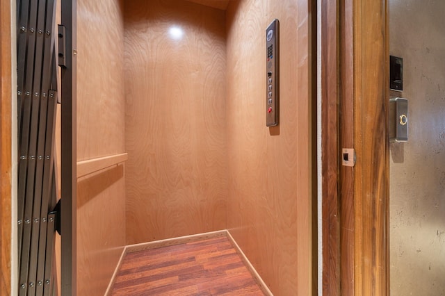 1245 Lagoon Dr, Crystal Beach, TX 77650 - details with wood-type flooring, elevator, and wood walls