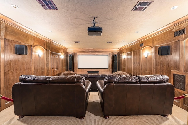 1245 Lagoon Dr, Crystal Beach, TX 77650 - carpeted cinema with wood walls, crown molding, and a textured ceiling