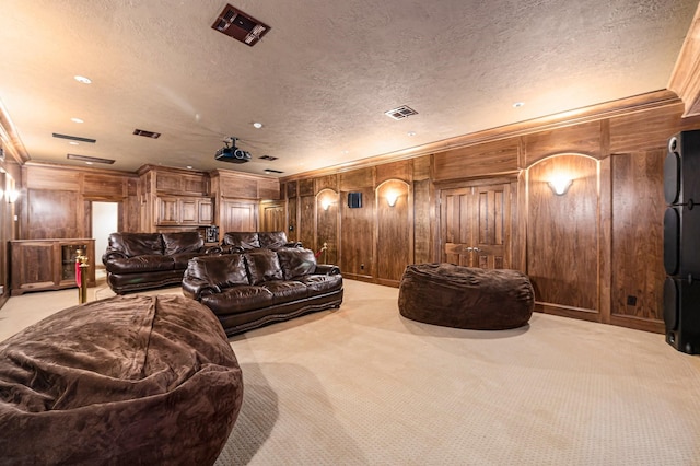 1245 Lagoon Dr, Crystal Beach, TX 77650 - cinema room featuring wood walls, light colored carpet, a textured ceiling, and ornamental molding