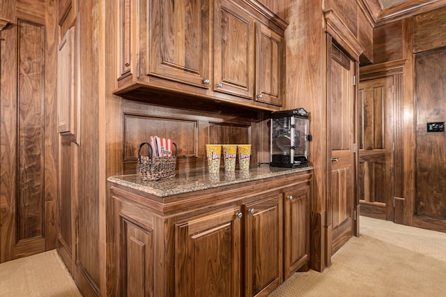 1245 Lagoon Dr, Crystal Beach, TX 77650 - bar featuring wood walls, dark stone counters, and light carpet