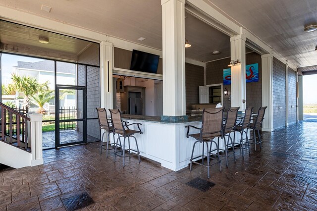 1245 Lagoon Dr, Crystal Beach, TX 77650 - kitchen with kitchen peninsula, a kitchen breakfast bar, and white cabinetry