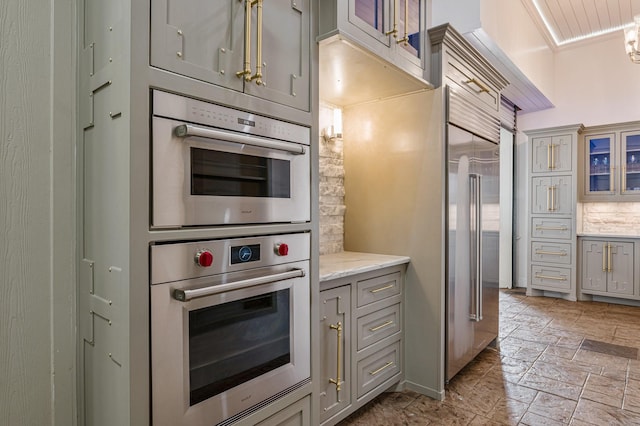 1245 Lagoon Dr, Crystal Beach, TX 77650 - kitchen featuring gray cabinets, light stone counters, and stainless steel double oven