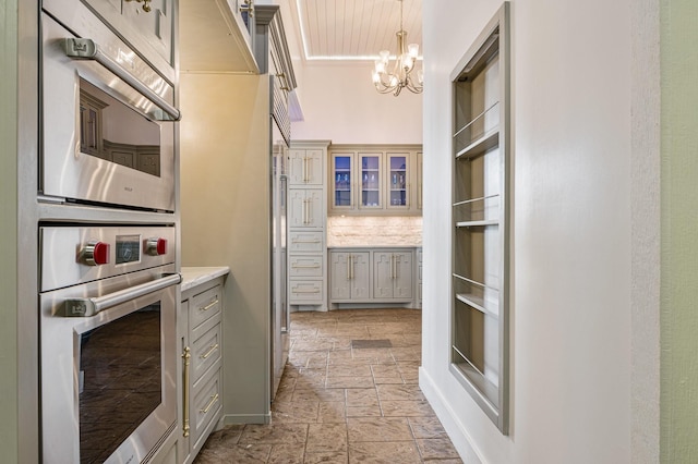 1245 Lagoon Dr, Crystal Beach, TX 77650 - kitchen with decorative backsplash, ornamental molding, stainless steel double oven, decorative light fixtures, and a notable chandelier