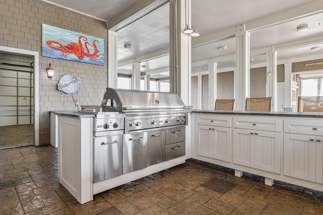 1245 Lagoon Dr, Crystal Beach, TX 77650 - kitchen with white cabinets and tile walls