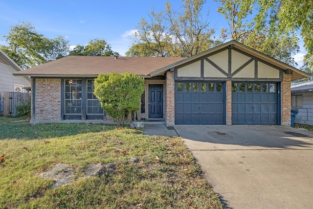 view of front of property featuring a garage and a front lawn