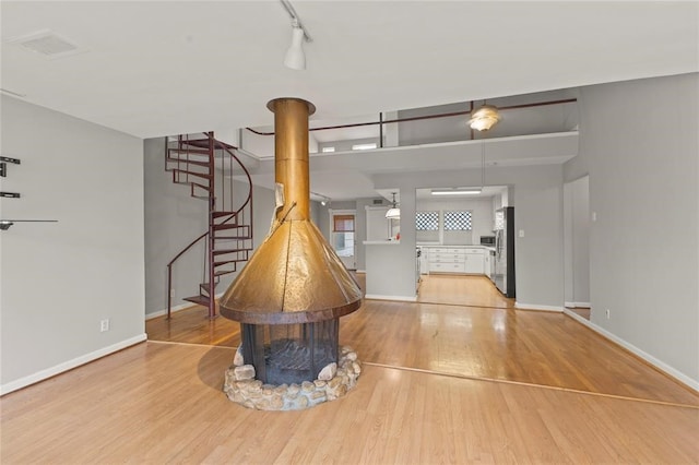 interior space with light wood-type flooring and rail lighting