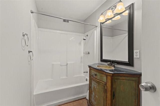 bathroom featuring vanity, wood-type flooring, and tub / shower combination