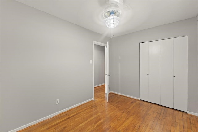 unfurnished bedroom with light hardwood / wood-style floors and a closet